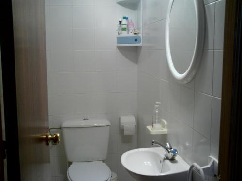 ein kleines Badezimmer mit Toilette und Waschbecken in der Unterkunft Primera línea de playa casita adosada in Chiclana de la Frontera