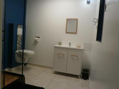a bathroom with a toilet and a sink at Domaine de buffevent in Cintegabelle