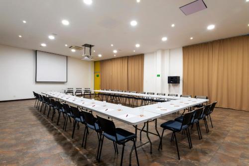 a large conference room with a long table and chairs at Pop Art Hotel CLC Puerto Mamonal Cartagena in Cartagena de Indias