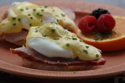 a plate of food with eggs and fruit on it at Ray's Bucktown Bed and Breakfast in Chicago