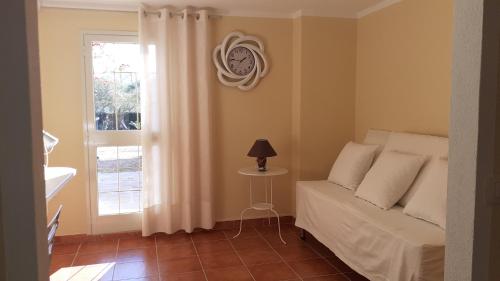 a bedroom with a bed and a window and a lamp at Li Muntigeddi in San Teodoro