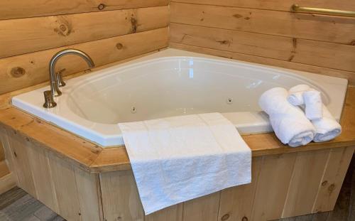 a bath tub with two rolled towels in a bathroom at Briarwood Cabin by Amish Country Lodging in Berlin