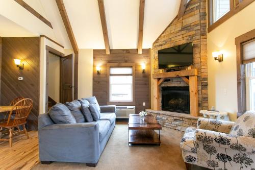 a living room with a couch and a fireplace at Country Bliss Cottage by Amish Country Lodging in Berlin