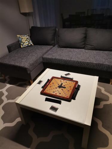 a living room with a table and a couch at Przystanek Przywidz in Trzepowo