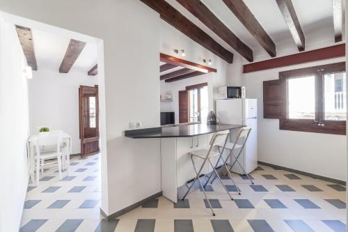a kitchen with a counter and a refrigerator at Can Boss - Turismo de Interior in Palma de Mallorca