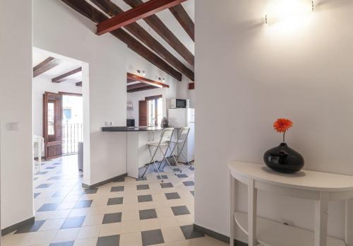 a kitchen with white walls and a checkered floor at Can Boss - Turismo de Interior in Palma de Mallorca