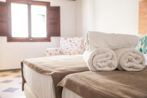 a room with a chair with towels on it at Can Boss - Turismo de Interior in Palma de Mallorca