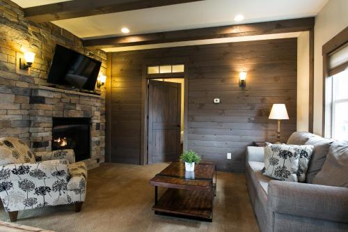 a living room with a couch and a fireplace at Village Dreams Cottage by Amish Country Lodging in Berlin