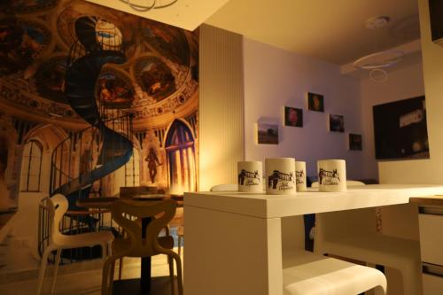 a room with a table and a painting on the wall at B&B Acquedotto in Corigliano Calabro