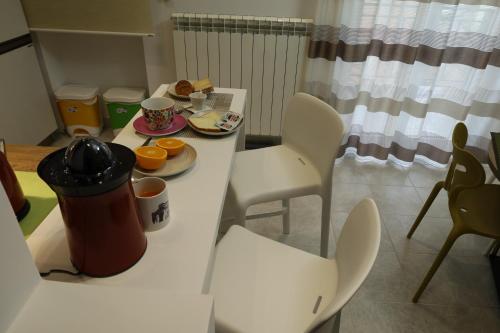 a table and chairs with a plate of food on it at B&B Acquedotto in Corigliano Calabro