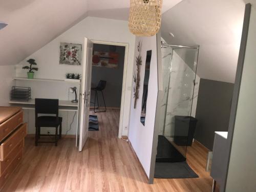 an attic room with a desk and a mirror at Chez Chris in Oloron-Sainte-Marie