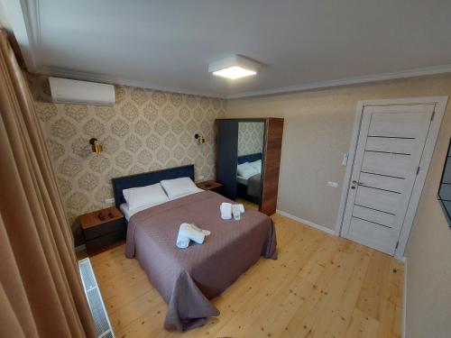 a bedroom with a bed with two towels on it at Apartment Elle2 in Tbilisi City