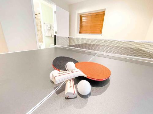 a ping pong racket and balls on the floor of a room at 2 Master Suites! Pet Friendly With MTN Views in Palmer Lake