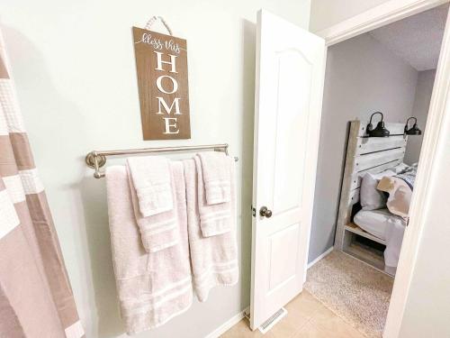 a bathroom with white towels on a towel rack at 2 Master Suites! Pet Friendly With MTN Views in Palmer Lake