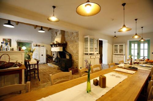 une cuisine et une salle à manger avec une grande table en bois dans l'établissement Hotel Village Balatura - exclusive VEGGIE, à Tribalj
