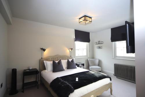 a bedroom with a bed with black and white pillows at No 1 Bank Chambers in Sleaford