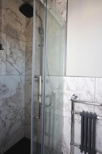 a shower with a glass door in a bathroom at The SOLO No 1 Bank Chambers in Sleaford