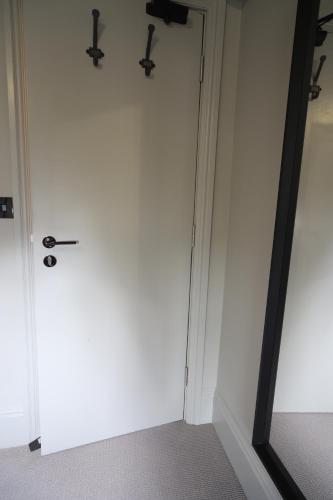 a room with a white door and a mirror at The SOLO No 1 Bank Chambers in Sleaford
