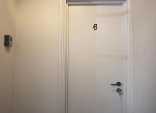 a white door with the number six on it at The SOLO No 1 Bank Chambers in Sleaford