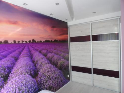 a purple lavender field mural in a room at Lukusowy apartament dla Pary in Mrągowo