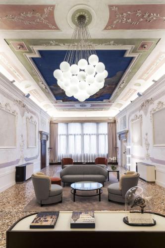 a living room with a ceiling with a chandelier at Radisson Collection Hotel, Palazzo Nani Venice in Venice
