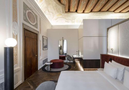 a hotel room with a bed and a desk at Radisson Collection Hotel, Palazzo Nani Venice in Venice