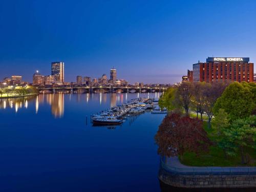 uma vista para um rio com barcos numa cidade em The Royal Sonesta Boston em Cambridge