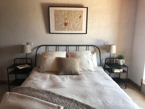 a bedroom with a bed with two end tables at Il Terrazzo in Santo Stefano di Sessanio
