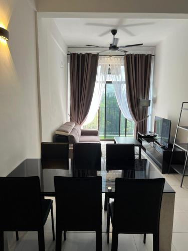 a living room with a table and chairs and a couch at Imperio Professional Suites @ FD Homestay in Alor Setar