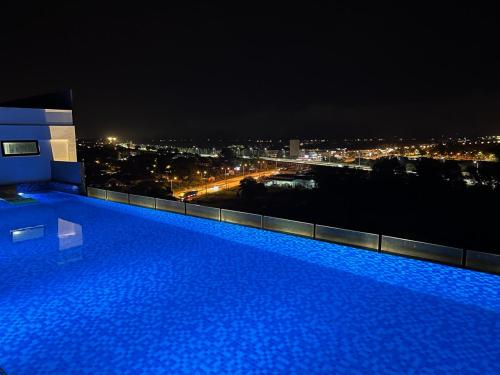 a swimming pool on top of a building at night at Imperio Professional Suites @ FD Homestay in Alor Setar