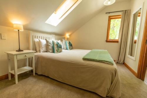 a bedroom with a large bed and a window at Wanaka Homestead Lodge & Cottages in Wanaka