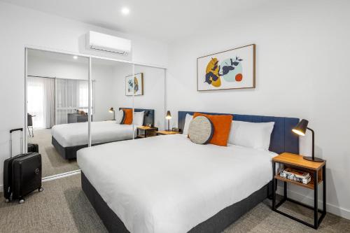 Tempat tidur dalam kamar di Quest Wangaratta