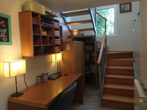 a home office with a desk and a staircase at DECKS AL LAGO in San Carlos de Bariloche