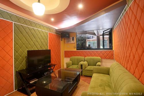 a living room with a couch and a tv at Momarco Forest Cove in Tanay