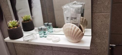 a shelf in a bathroom with some items on it at Focus Lux in Miercurea-Ciuc