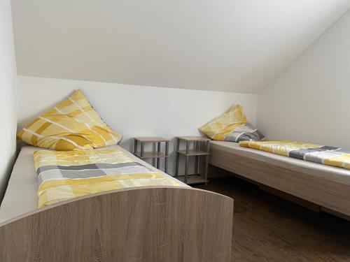 two beds sitting in a room with at Fam M&H Schönes Zimmer Vermieten in Wangen Im Allgäu in Wangen im Allgäu