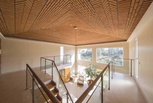 a staircase in a room with a wooden ceiling at Casa das Oliveiras - OLIVE TREE in Monchique