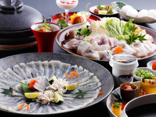 a table with many plates of food on it at Awaji Seaside Resort in Iwaya 3000 in Awaji