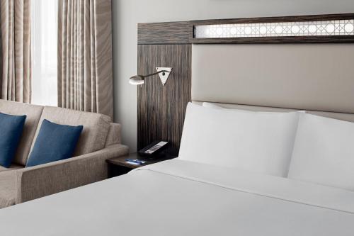 a hotel room with a bed and a couch at Holiday Inn Express Dubai, Jumeirah by IHG in Dubai