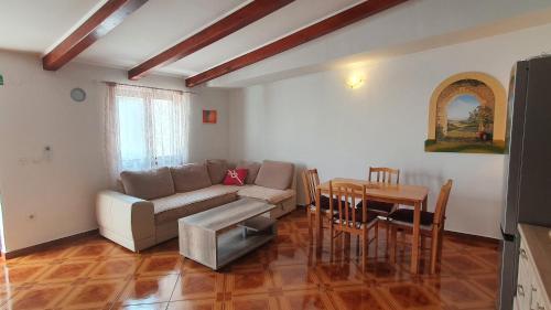 - un salon avec un canapé et une table dans l'établissement Apartmani Sirovica, à Čunski