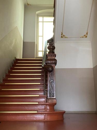 a staircase in a building with a mirror on the wall at Hotel Gunia in Berlin