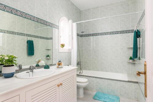 a bathroom with a sink and a toilet and a shower at Villa Moll Moll in Cala Blanca