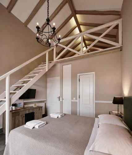 a bedroom with a large bed and a staircase at Varaba Country House in Markopoulo