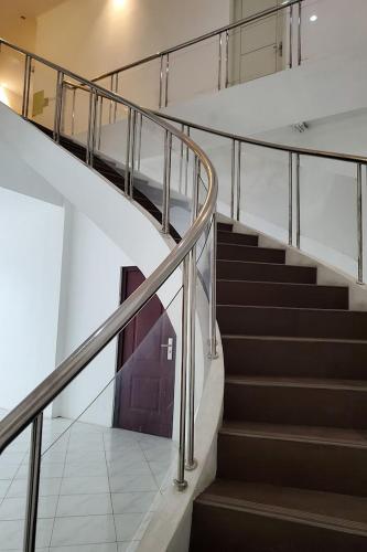 a set of stairs in a building with a door at RedDoorz near Simpang Tujuh Kudus in Kudus