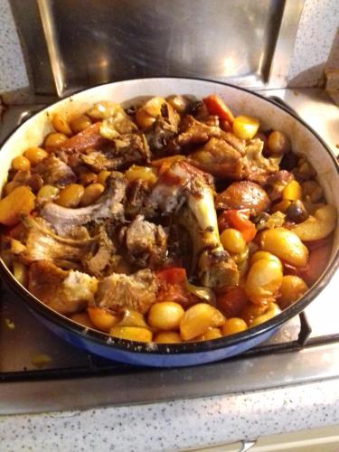 a pan filled with meat and vegetables on a stove at OPG Vuk bed&breakfast "Čarobni snovi" in Darda