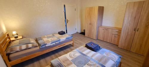 a bedroom with two beds and a cabinet at C. Wulf Gästezimmer in Bückeburg