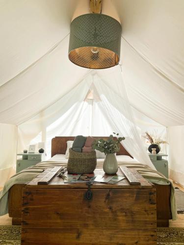 a bedroom with a bed with a tent at Vintage tent at the Lovsin Estate in Metlika