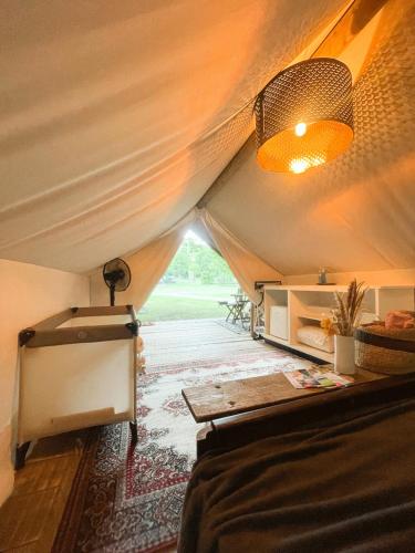 a room with a bed and a tent at Vintage tent at the Lovsin Estate in Metlika