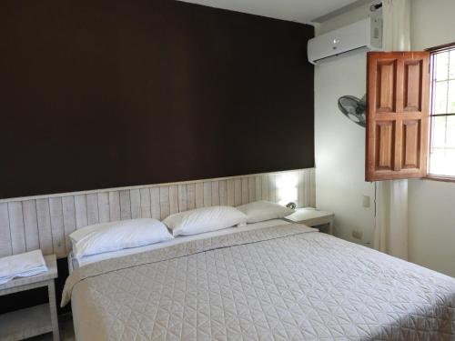 a bedroom with a bed and a black wall at Colina Buena vista A4 in Jarabacoa