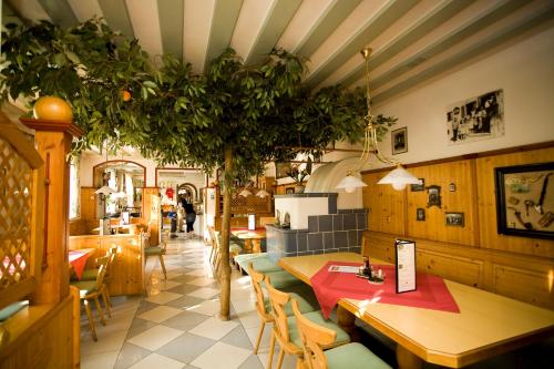 a restaurant with a table and a tree in it at ROSSLWIRT-Rast in Strass im Attergau